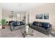 Open living area with two sofas and a glass-top coffee table at 2220 Wyndham Palms Way, Kissimmee, FL 34747