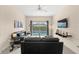 Living room with a view of the pool and comfortable seating at 2220 Wyndham Palms Way, Kissimmee, FL 34747