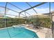 Screened pool and patio with spa and seating area at 2220 Wyndham Palms Way, Kissimmee, FL 34747