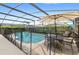 Screened pool and patio area with table and chairs at 2220 Wyndham Palms Way, Kissimmee, FL 34747