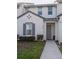 Front view of a two-story townhome with gray door at 236 Captiva Dr, Davenport, FL 33896