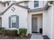 Front view of a two-story townhome with gray door and shutters at 236 Captiva Dr, Davenport, FL 33896