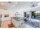 Open floor plan with modern kitchen and adjacent living room overlooking the pool at 236 Captiva Dr, Davenport, FL 33896