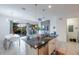 Open concept kitchen and living area with access to backyard and pool at 236 Captiva Dr, Davenport, FL 33896