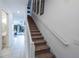 Modern staircase with carpeted steps and white railing at 236 Captiva Dr, Davenport, FL 33896