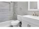 Bathroom with a white vanity, gray accent wall, brushed silver fixtures, and a shower at 2901 Primrose Ct, Orlando, FL 32803