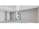 Spacious bedroom featuring a window with blue curtains and two white doors at 2901 Primrose Ct, Orlando, FL 32803