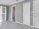 Bedroom featuring gray walls, tile floor, a large window, a shower, and white doors at 2901 Primrose Ct, Orlando, FL 32803