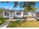 Charming home with a well-manicured front yard, complemented by mature trees and landscaping at 2901 Primrose Ct, Orlando, FL 32803