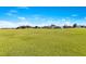 Expansive grassy field under a clear blue sky, offering potential for various recreational or development opportunities at 2901 Primrose Ct, Orlando, FL 32803