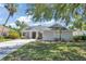 House exterior showcasing a well-maintained lawn and tree-lined street at 33 Acclaim At Lionspaw, Daytona Beach, FL 32124