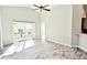 Spacious living room with wood-look tile floors and access to the backyard at 337 Silver Palms Cir, Davenport, FL 33837