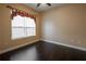 Simple bedroom with dark hardwood floors and window at 38633 Lakeview Walk, Lady Lake, FL 32159