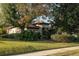 House exterior surrounded by lush landscaping at 38633 Lakeview Walk, Lady Lake, FL 32159
