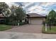 One-story home with a brick driveway and landscaped yard at 38633 Lakeview Walk, Lady Lake, FL 32159
