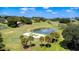 Aerial view of a golf course with a pond at 38633 Lakeview Walk, Lady Lake, FL 32159