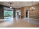 Spacious living room with tile floors and sliding doors to a patio at 38633 Lakeview Walk, Lady Lake, FL 32159