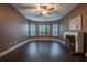 Bright living room with hardwood floors, fireplace, and large windows at 38633 Lakeview Walk, Lady Lake, FL 32159