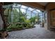 Relaxing screened patio with pond and waterfall feature at 38633 Lakeview Walk, Lady Lake, FL 32159