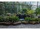 Screened patio with lush landscaping and tranquil waterfall at 38633 Lakeview Walk, Lady Lake, FL 32159