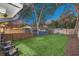 Backyard with grassy lawn, shed and wooden fence at dusk at 413 W Princeton St, Orlando, FL 32804