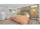 Bright bedroom with a tropical-themed accent wall and comfortable furnishings at 413 W Princeton St, Orlando, FL 32804