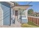 Side view of the house showing the front door and a modern wooden fence at 413 W Princeton St, Orlando, FL 32804