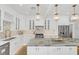 Modern kitchen boasts white cabinets, marble countertops, and gold accents at 413 W Princeton St, Orlando, FL 32804