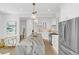 Gourmet kitchen with marble island, stainless steel appliances, and white cabinets at 413 W Princeton St, Orlando, FL 32804