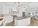 Modern kitchen featuring white cabinets, marble countertops, and stainless steel appliances at 413 W Princeton St, Orlando, FL 32804