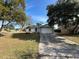 White house with a teal front door, newly paved driveway, and well-maintained lawn at 581 Calusa Ter, Deltona, FL 32738