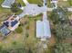 Aerial view of two homes, one with a pool and solar panels, the other with a large yard at 604 Elfrida Way, Kissimmee, FL 34758