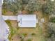 An aerial view of a single-Gathering home with a gray roof and a spacious yard at 604 Elfrida Way, Kissimmee, FL 34758