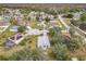 Aerial view of a residential neighborhood showcasing a house with a spacious backyard at 604 Elfrida Way, Kissimmee, FL 34758
