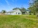 A newly constructed home with a large grassy backyard and a clear view of the sky at 604 Elfrida Way, Kissimmee, FL 34758