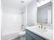 Bathroom with a shower/tub combo and modern vanity with a quartz countertop at 604 Elfrida Way, Kissimmee, FL 34758
