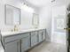Modern bathroom with double vanity, gray cabinets, and gold accents at 604 Elfrida Way, Kissimmee, FL 34758