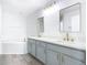 Updated bathroom with double vanity, gold fixtures, and corner bathtub at 604 Elfrida Way, Kissimmee, FL 34758