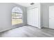 Bright bedroom with an arched window and ample closet space at 604 Elfrida Way, Kissimmee, FL 34758