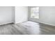 Spacious bedroom with large window and wood-look floors at 604 Elfrida Way, Kissimmee, FL 34758