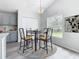 Bright dining room with a four-person table and chairs, and natural light at 604 Elfrida Way, Kissimmee, FL 34758