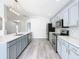 Modern kitchen with gray cabinets, white countertops, and stainless steel appliances at 604 Elfrida Way, Kissimmee, FL 34758
