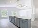 Open concept kitchen with island, gray cabinets, and stainless steel appliances at 604 Elfrida Way, Kissimmee, FL 34758
