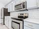 Stainless steel appliances and gray cabinets highlight this modern kitchen at 604 Elfrida Way, Kissimmee, FL 34758