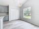 Bright kitchen features gray cabinets, quartz countertops, and a view to the backyard at 604 Elfrida Way, Kissimmee, FL 34758
