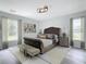 Main bedroom with wood bed frame and neutral color palette at 604 Elfrida Way, Kissimmee, FL 34758