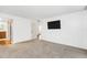 Spacious bedroom with carpeting, a mounted TV, and bathroom access at 690 Osceola Ave # 209, Winter Park, FL 32789