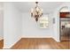 Dining room featuring hardwood floors and elegant chandelier at 690 Osceola Ave # 209, Winter Park, FL 32789