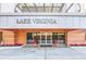 Main entrance to Lake Virginia with welcoming landscaping and signage at 690 Osceola Ave # 209, Winter Park, FL 32789