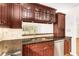 Kitchen with granite countertops, stainless steel appliances, and wood cabinets at 690 Osceola Ave # 209, Winter Park, FL 32789